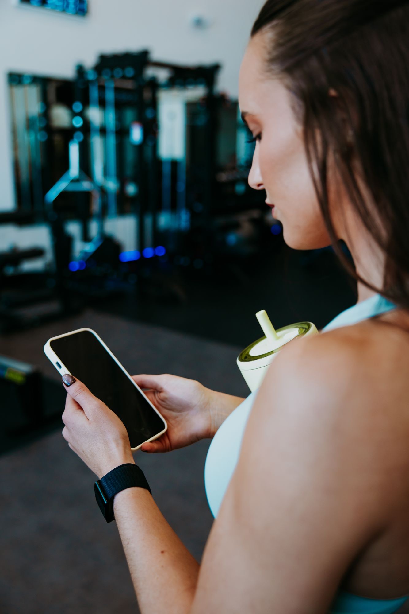 Emma checking her phone in the gym