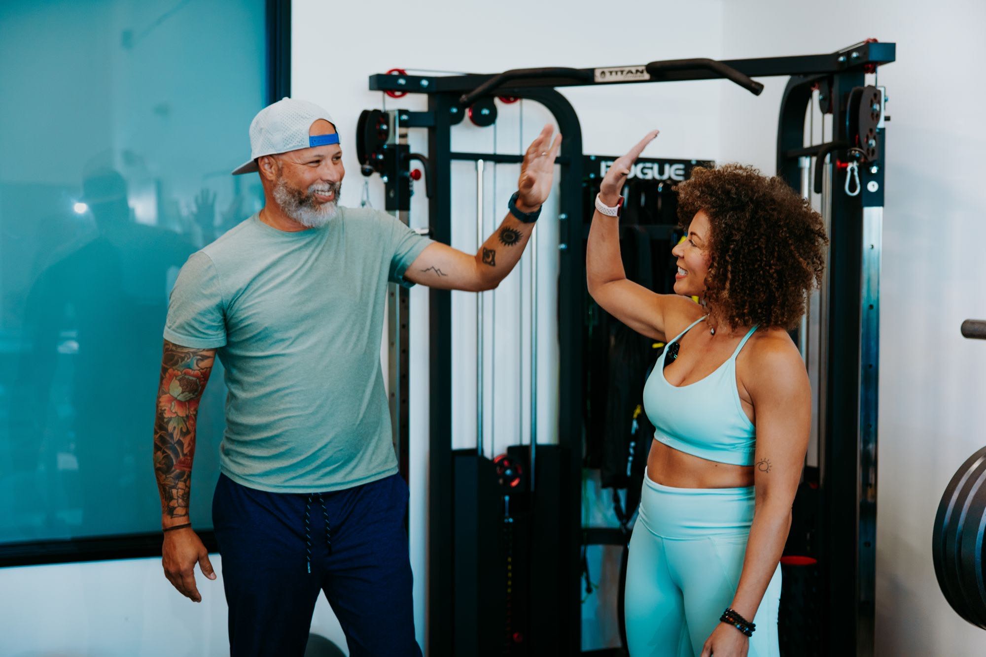 Andrea and Jason sharing a high-five in the gym